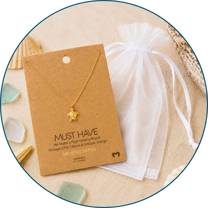 Gold sea turtle necklace with a white organza gift bag — 18k gold dipped sea turtle pendant necklace ready to gift