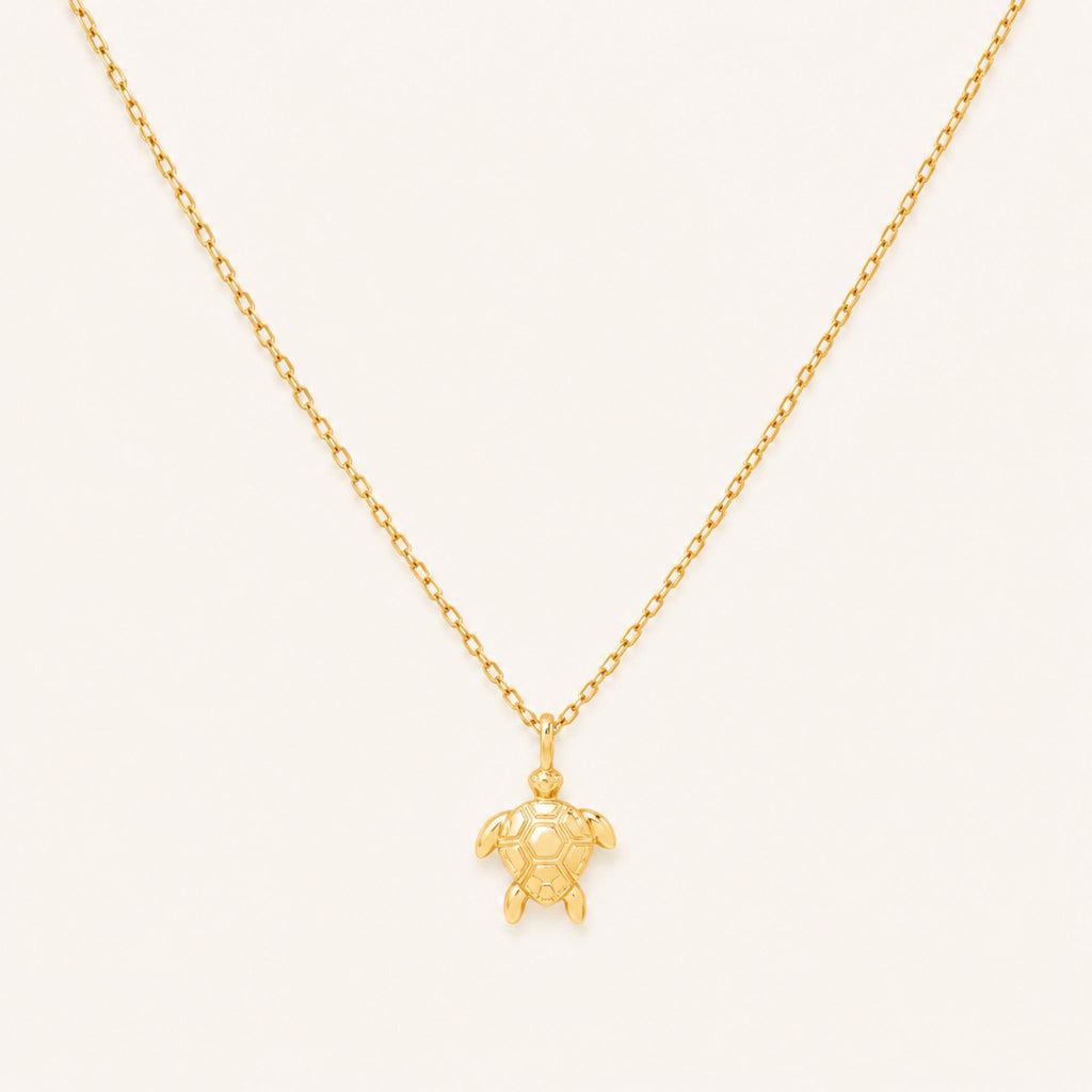 Gold sea turtle pendant necklace on a 16-inch chain — 18k gold dipped sea turtle jewelry on white background