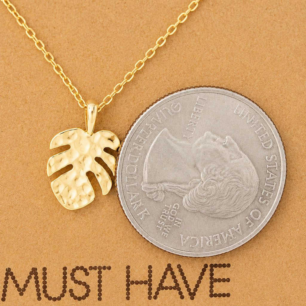 Dainty gold monstera pendant necklace on a jewelry card — 18k gold dipped monstera necklace for beach lovers