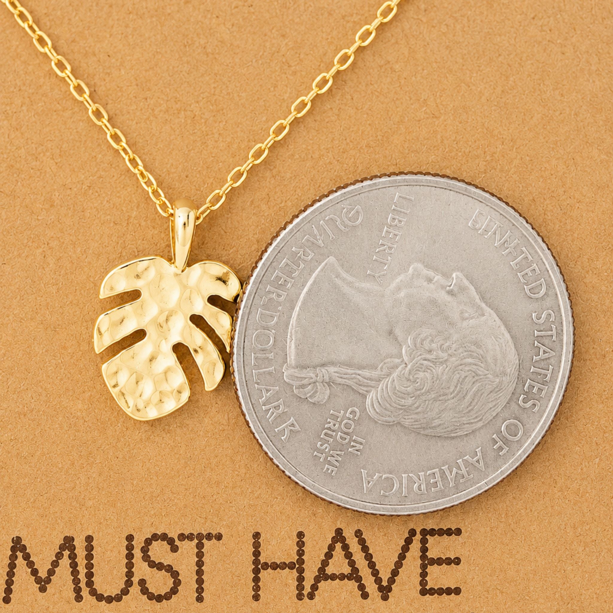 Dainty gold monstera pendant necklace on a jewelry card — 18k gold dipped monstera necklace for beach lovers