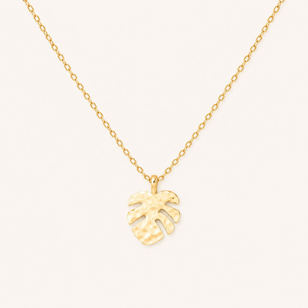 Gold monstera pendant necklace on a 16-inch chain — 18k gold dipped tropical monstera beach jewelry on white background