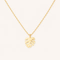 Gold monstera pendant necklace on a 16-inch chain — 18k gold dipped tropical monstera beach jewelry on white background