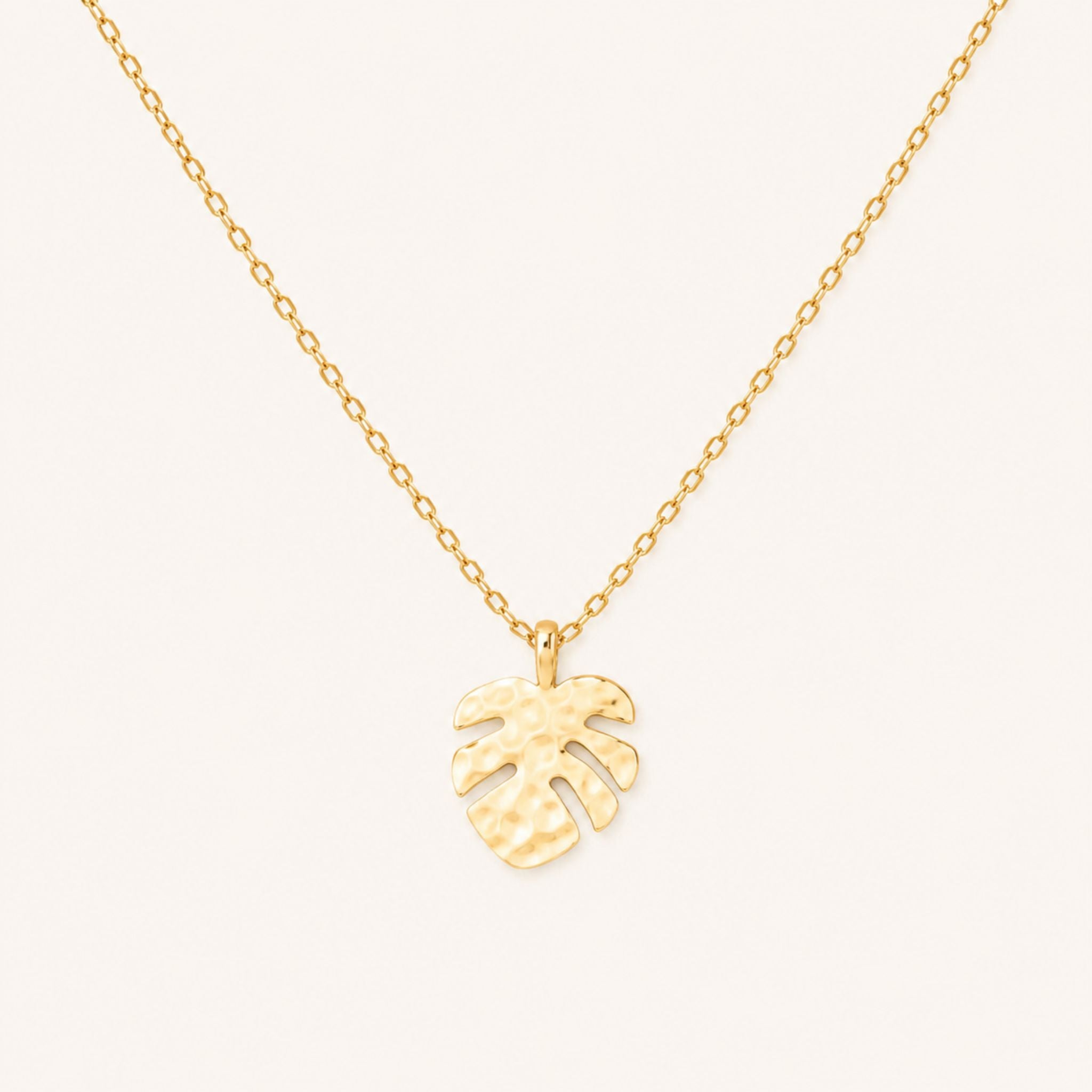 Gold monstera pendant necklace on a 16-inch chain — 18k gold dipped tropical monstera beach jewelry on white background