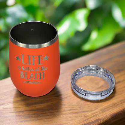 12 oz coral, engraved, "Life is better at the beach" metal wine tumbler with lid is perfect for keeping drinks cold on the beach or at the pool