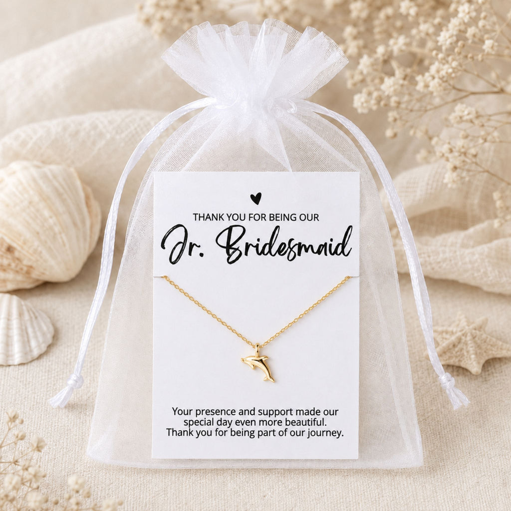 Jr. Bridesmaid dolphin necklace gift packaged in a white organza bag for a beach wedding