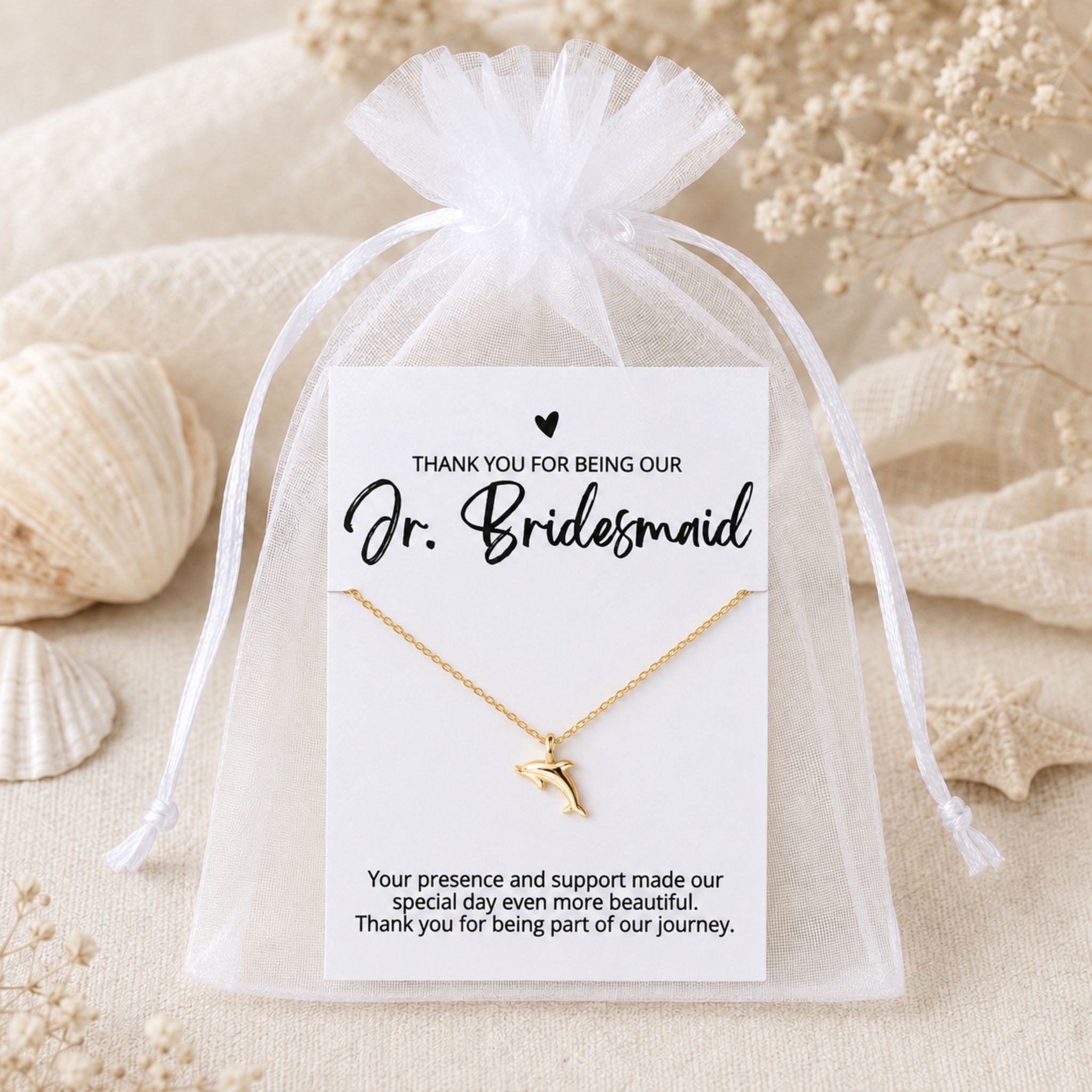Jr. Bridesmaid dolphin necklace gift packaged in a white organza bag for a beach wedding
