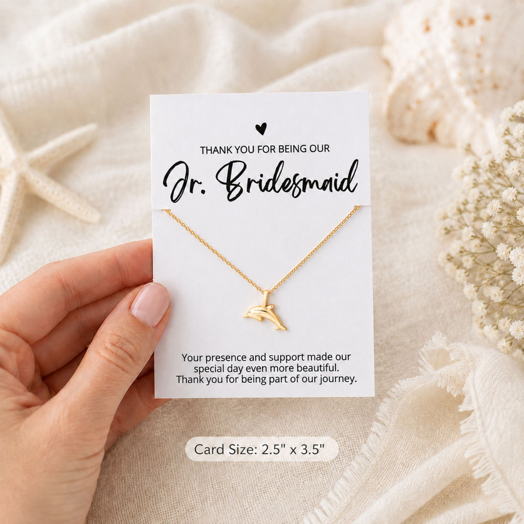 Jr. Bridesmaid beach wedding dolphin necklace gift shown in hand for size reference