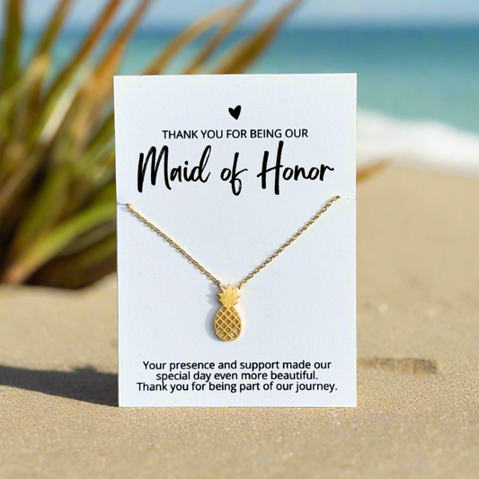 an 18k gold dipped pineapple necklace on a bridesmaid thank you card for an affordable bridal party gift for beach wedding