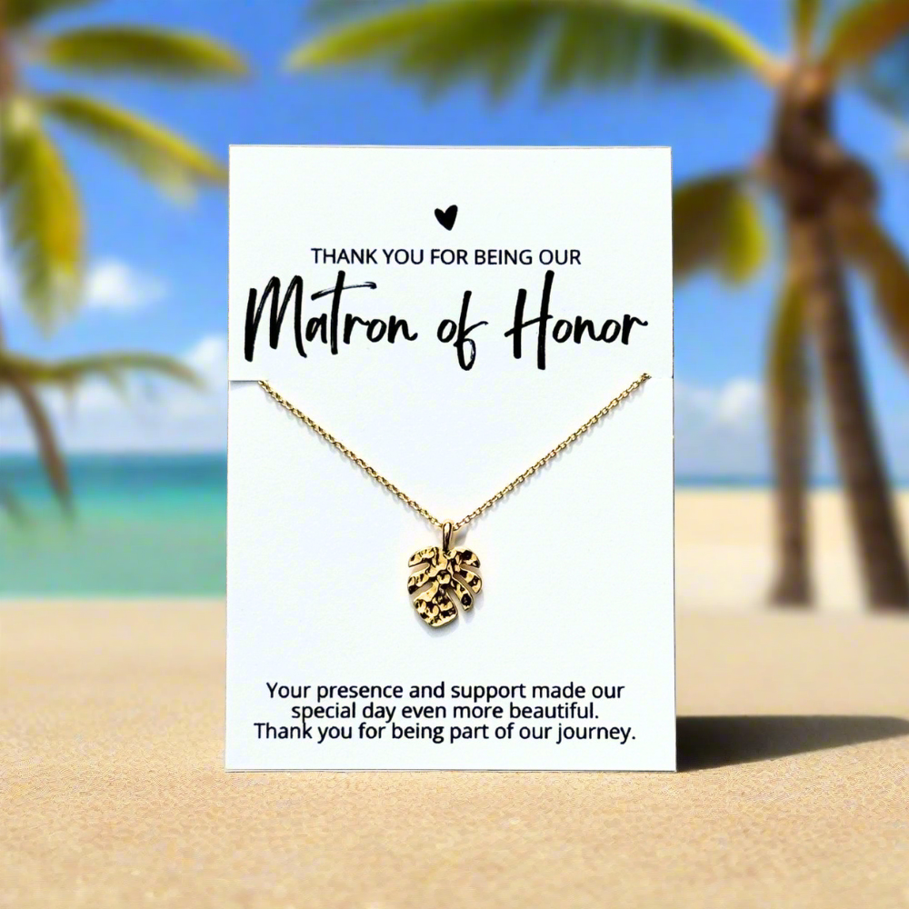 an 18k gold dipped tropical monstera leaf necklace on a bridesmaid thank you card for an affordable bridal party gift for beach wedding