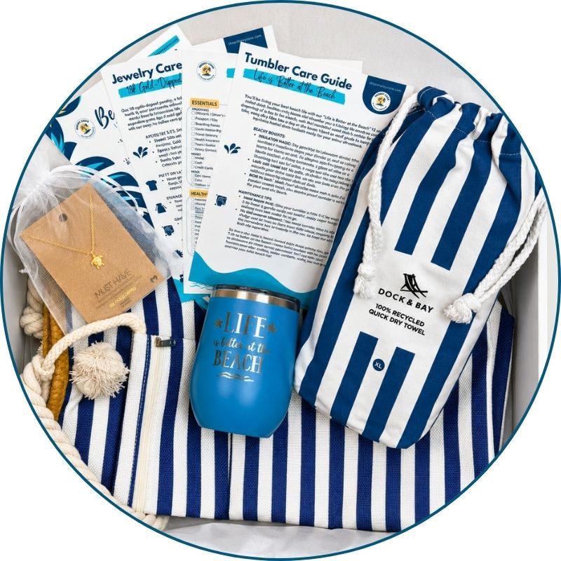Gift-ready navy beach gift set boxed with striped beach bag, navy striped towel, blue tumbler, gold-dipped sea turtle  beach necklace and bonus cards.