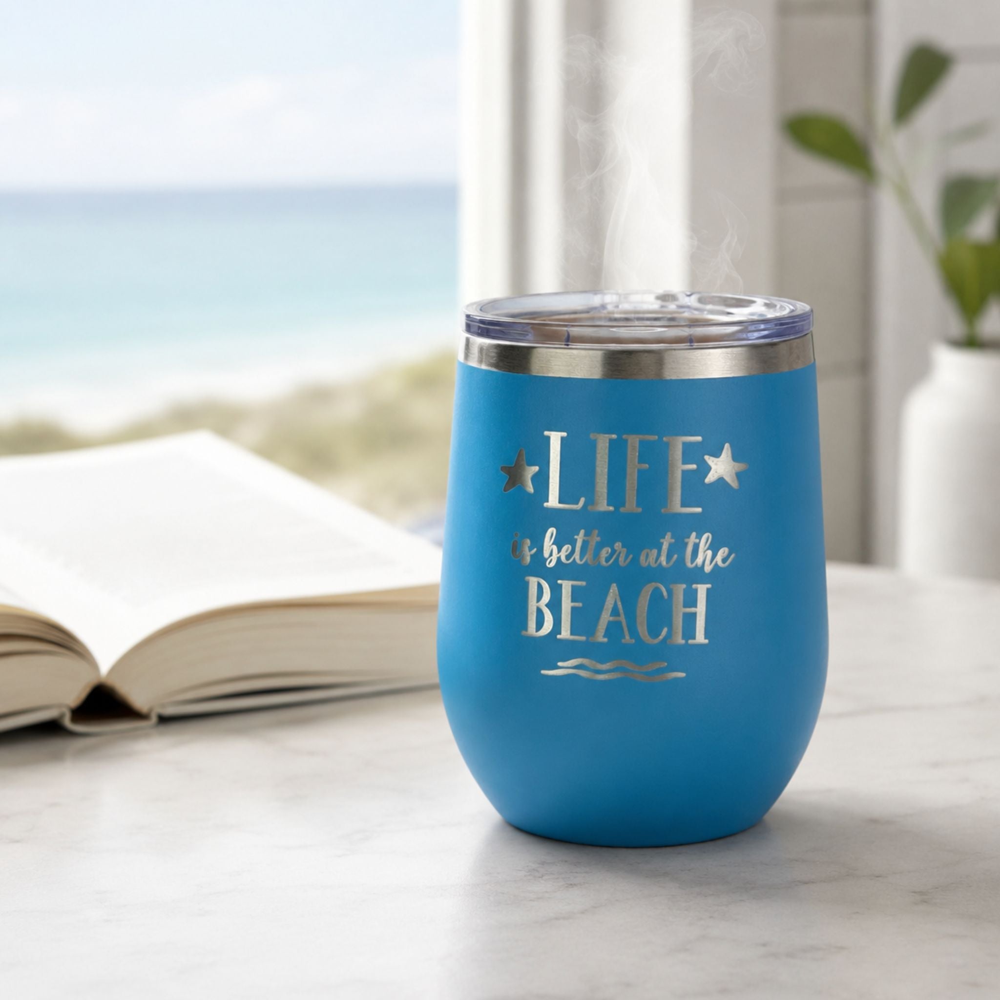 Ocean blue insulated wine tumbler for hot coffee in a calm coastal morning setting