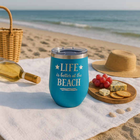 ocean blue metal wine tumbler with a beach picnic with wine and cheese