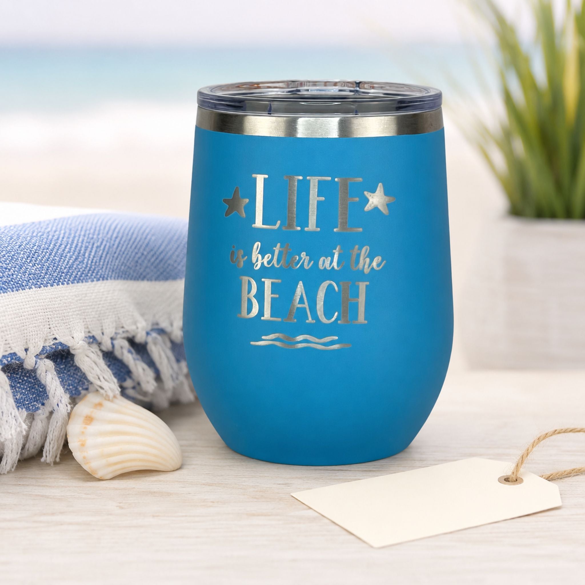 Ocean blue stainless steel wine tumbler styled as a thoughtful beach lover gift