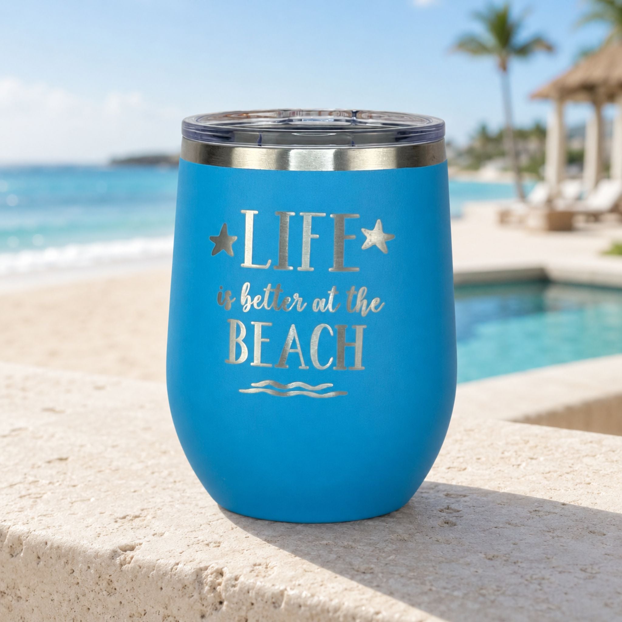 Ocean blue beach tumbler in a relaxing resort setting, part of a beach bag gift set for women and a thoughtful gift for beach lovers.
