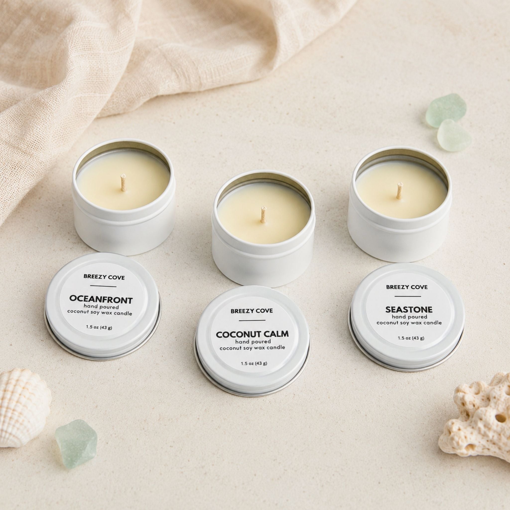 Open Beachside Mini Candle Trio showing nontoxic coconut-soy wax candles with cotton wicks, white tins, and coastal-inspired styling.