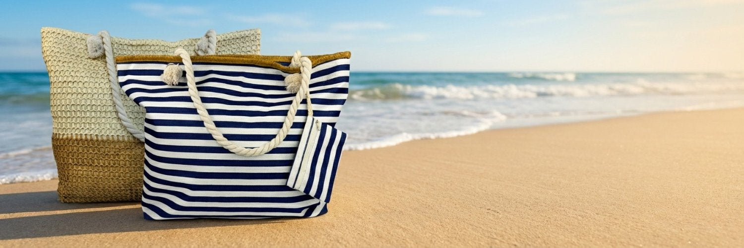 oversized beach bag totes, straw beach bag and Navy and white striped tote bag on a sandy beach with ocean waves in the background