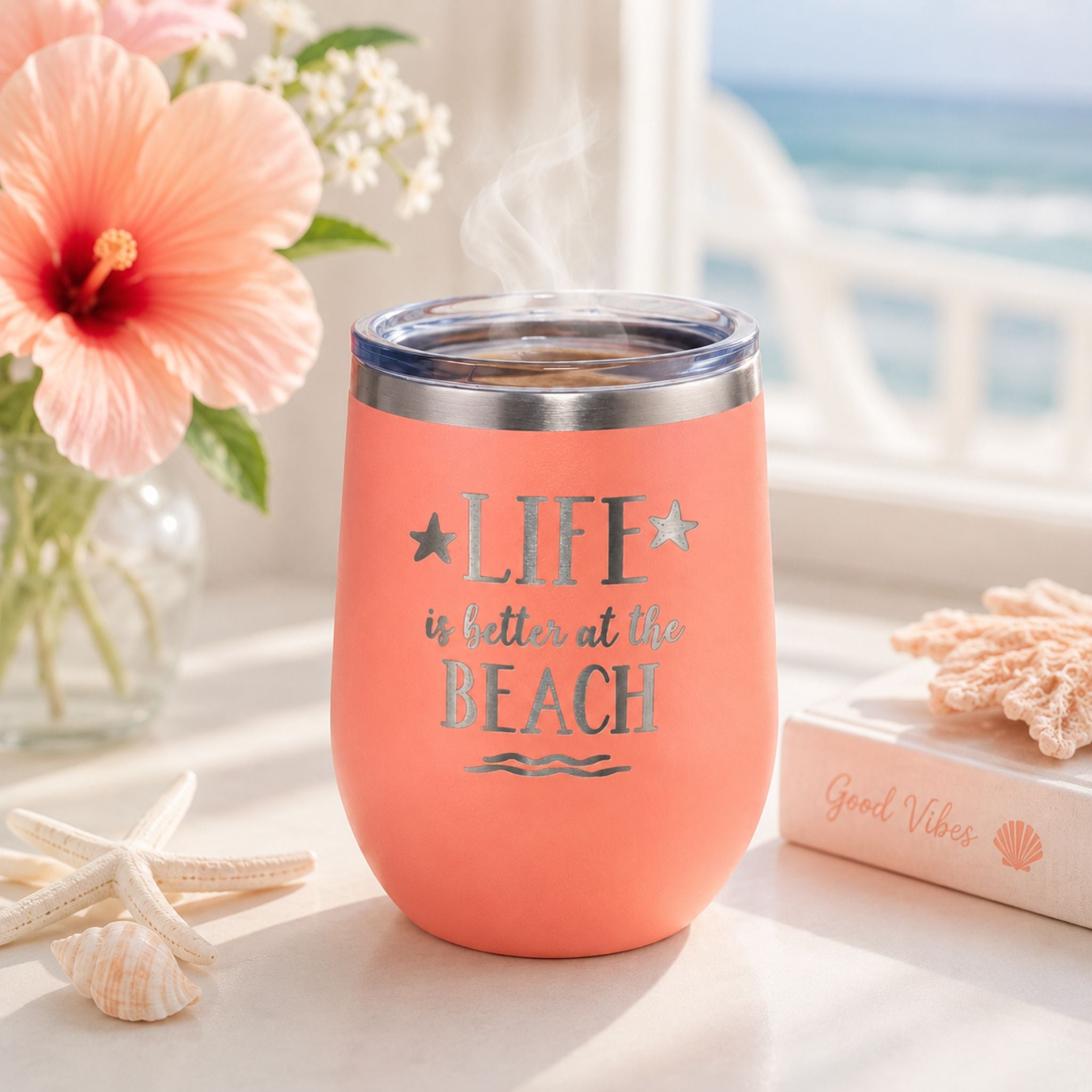 Peach insulated wine tumbler for hot coffee in a soft coastal morning setting