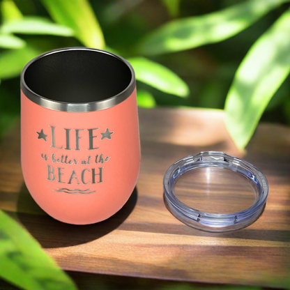 12 oz peach, engraved, "Life is better at the beach" metal wine tumbler with lid is perfect for keeping drinks cold on the beach or at the pool