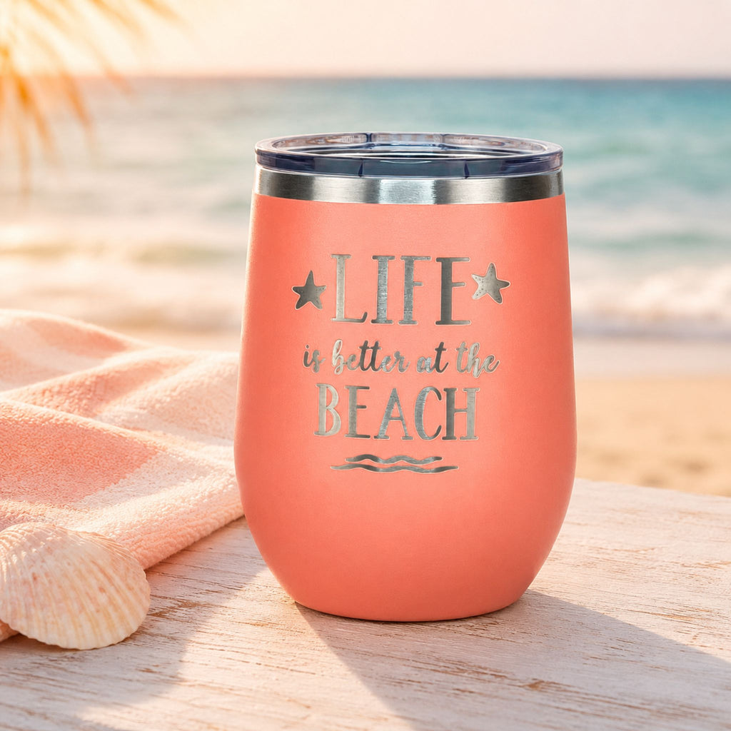 Peach wine tumbler with lid styled for beach days and coastal sipping