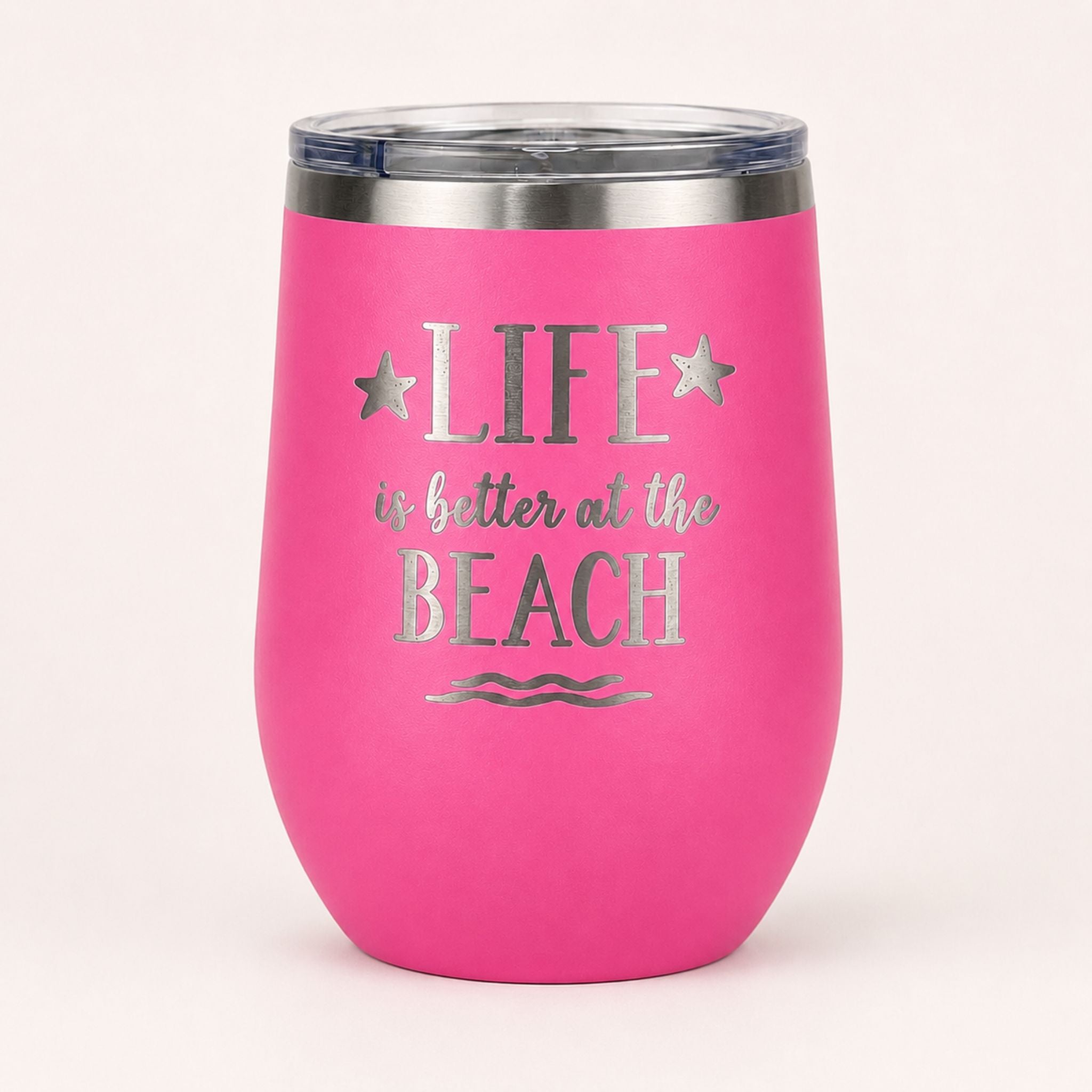 Pink insulated wine tumbler with lid on a clean light background