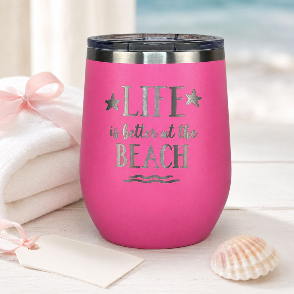 Pink stainless steel wine tumbler styled as a thoughtful beach lover gift