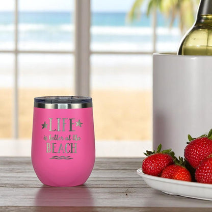 pink metal insulated wine tumbler with a plate of strawberries and a bottle of wine