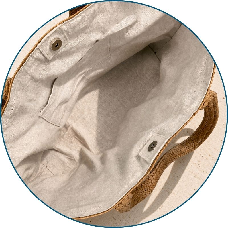 Sea Blessed raffia tote bag with lined interior, inner pocket, and snap closure