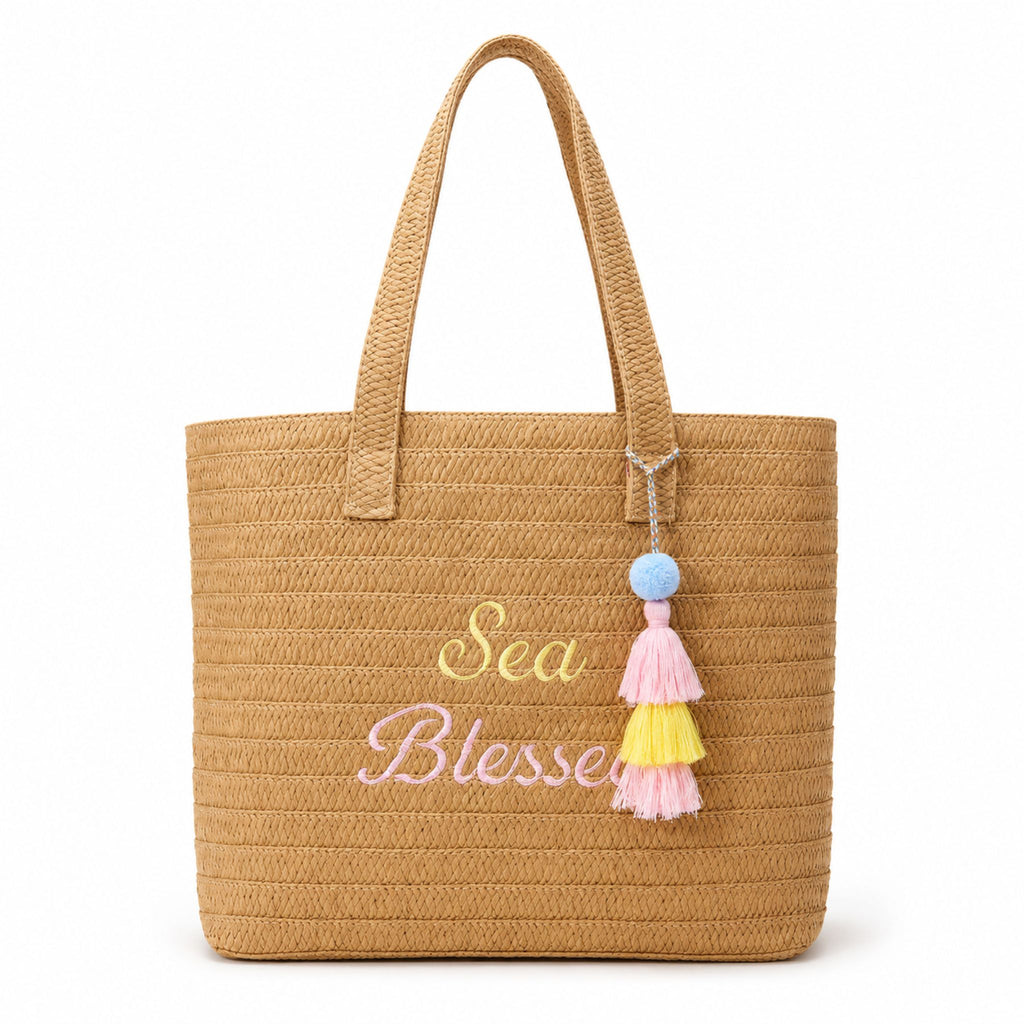 Front view of a Sea Blessed raffia tote bag with pastel embroidery and tassel