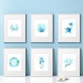 Set of 6 framed 8x10 watercolor beach art prints arranged on a soft blue background. Includes seashell, sea horse, coral, sand dollar, starfish, and crab designs.