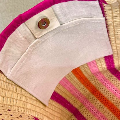 close-up of inside pocket in pink striped straw beach bag tote with magnetic closure