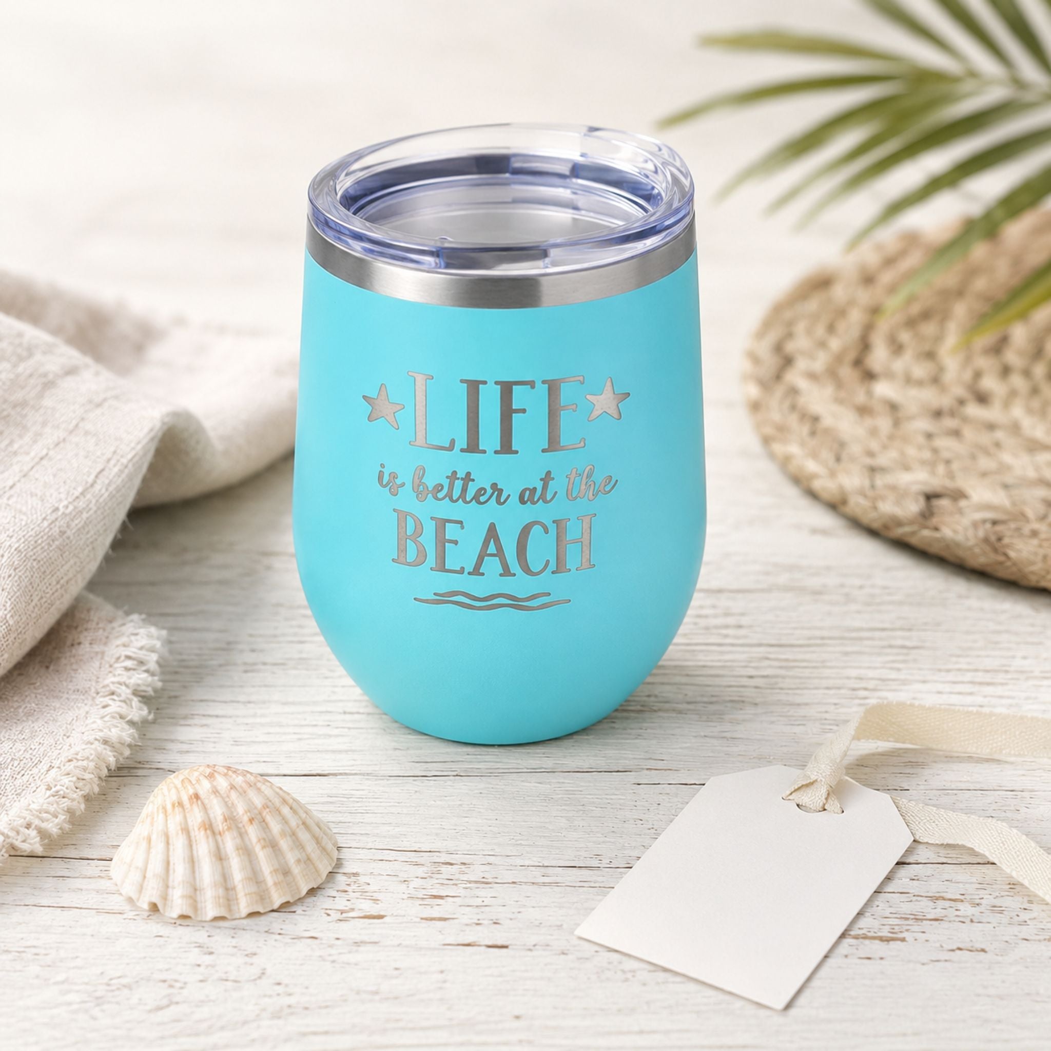 Teal beach insulated wine tumbler with lid styled as a thoughtful beach lover gift