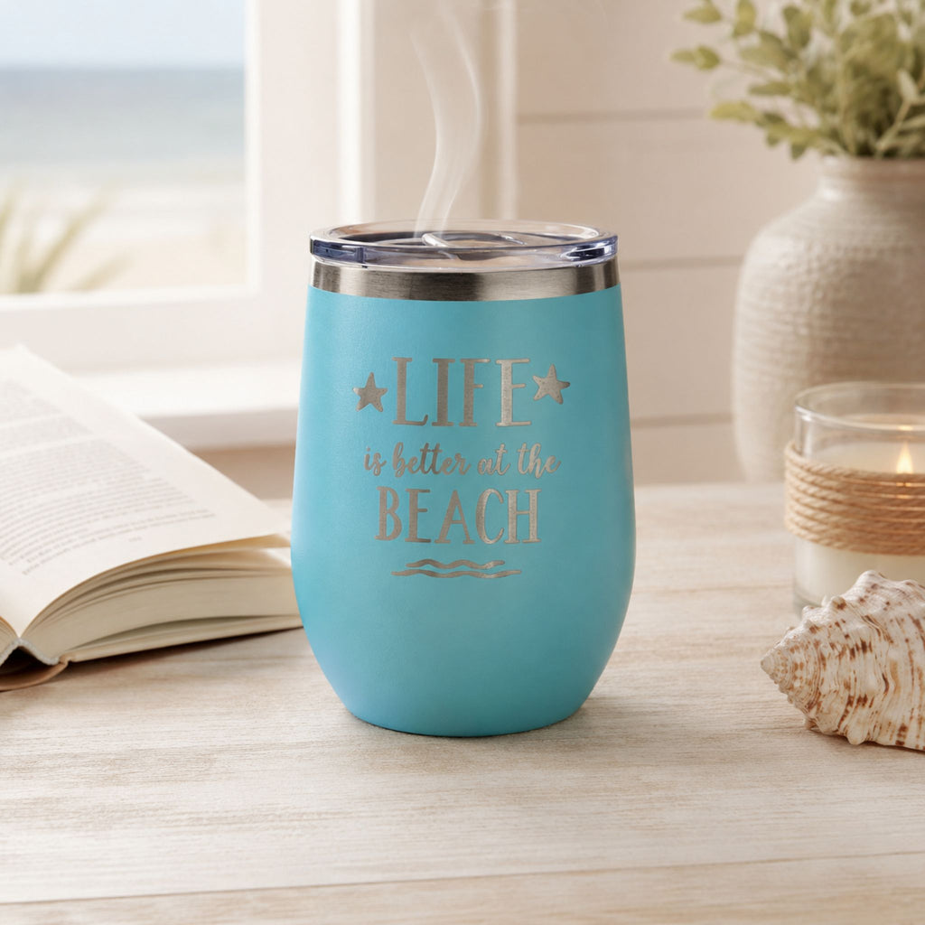 Teal beach insulated wine tumbler with lid in a cozy coastal coffee setting