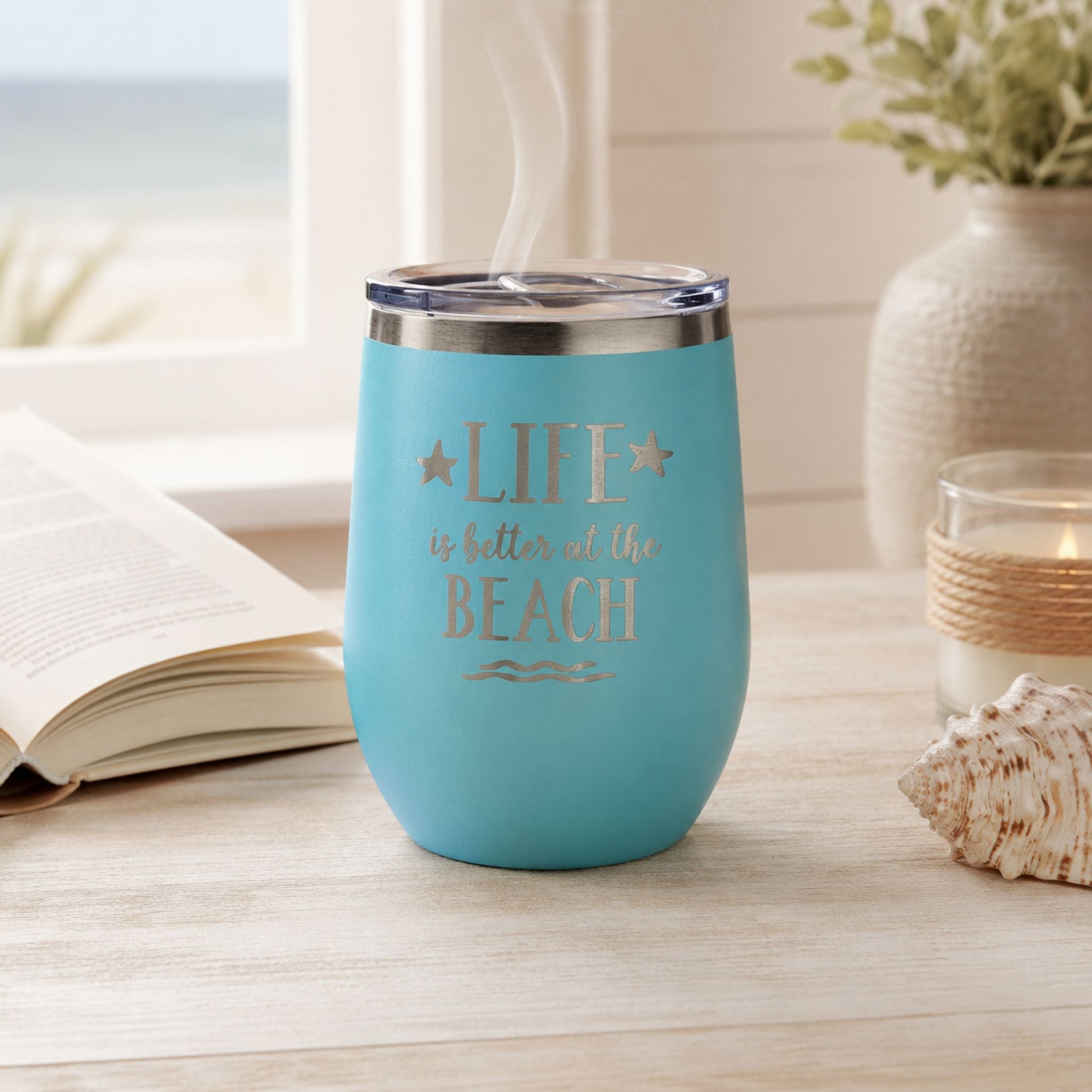 Teal beach insulated wine tumbler with lid in a cozy coastal coffee setting