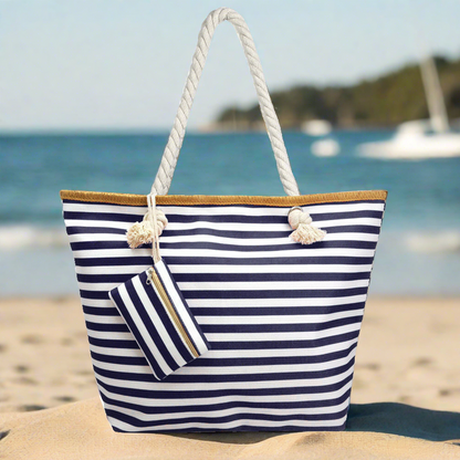 large, classic navy and white stripe pattern beach bag tote with rope handles on sandy beach