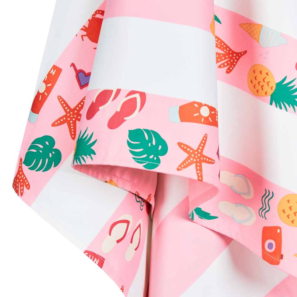 close up of pink striped beach pattern, quick dry, sand free kids beach towel with palm trees, starfish, pineapples and other beach themed items